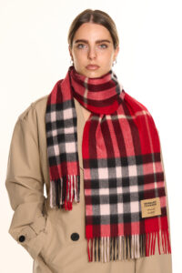 A folded red tartan cashmere scarf.